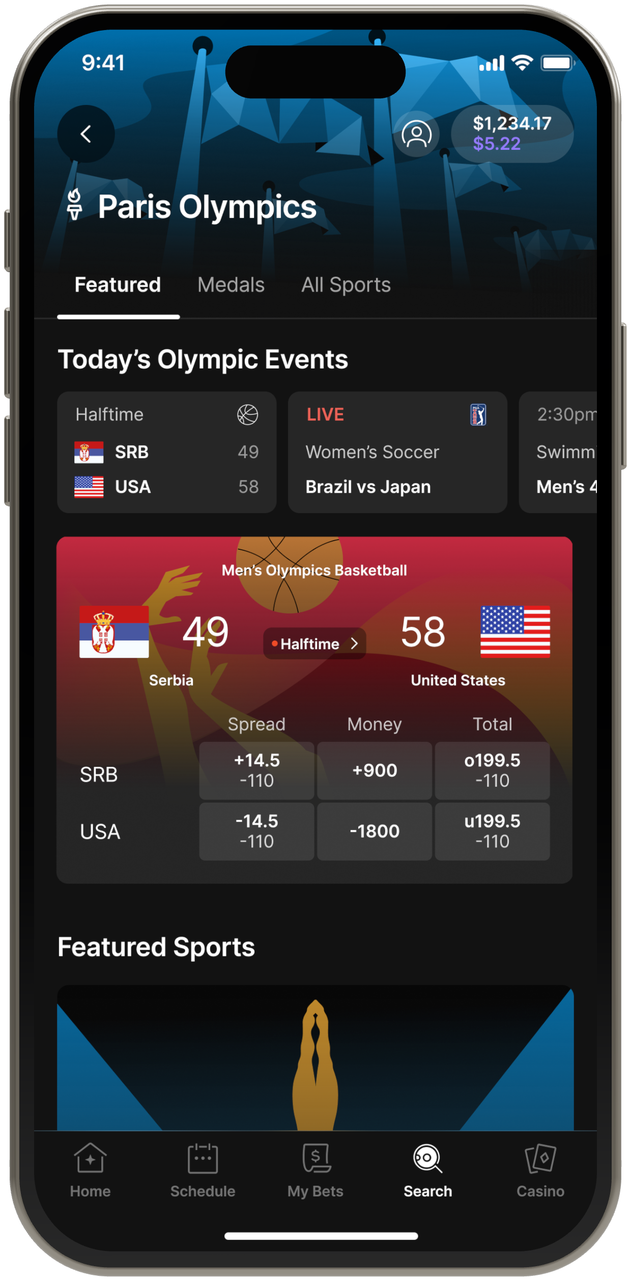 The Paris Olympics hub on an iPhone: today’s Olympic events, with Serbia versus the United States in men’s basketball at halftime, 49–58.
