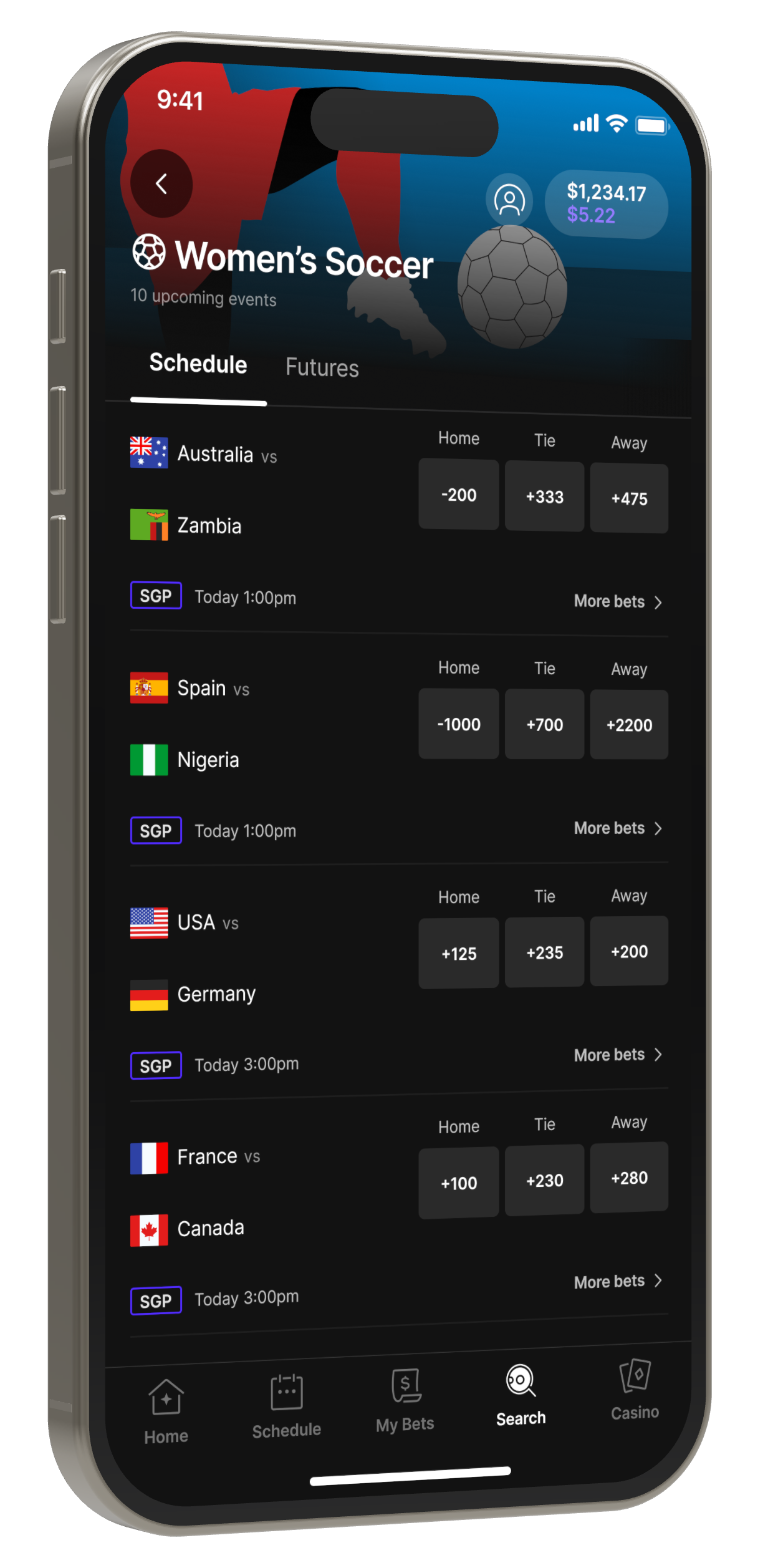 The Women’s Soccer event page on an iPhone, angled toward the center: the day’s group matches, each with home, tie, and away odds.